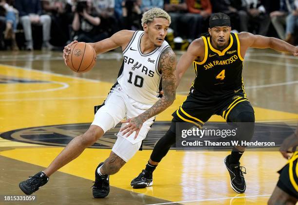 Jeremy Sochan of the San Antonio Spurs dribbles the ball past Moses Moody of the Golden State Warriors during the second quarter of an NBA In-Season...