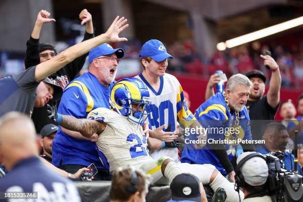 Kyren Williams of the Los Angeles Rams celebrates with fans after scoring a receiving touchdown during the second quarter against the Arizona...