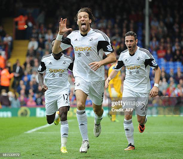 Swansea City's Spanish midfielder Miguel Michu celebrates scoring his team's first goal during the English Premier League football match between...