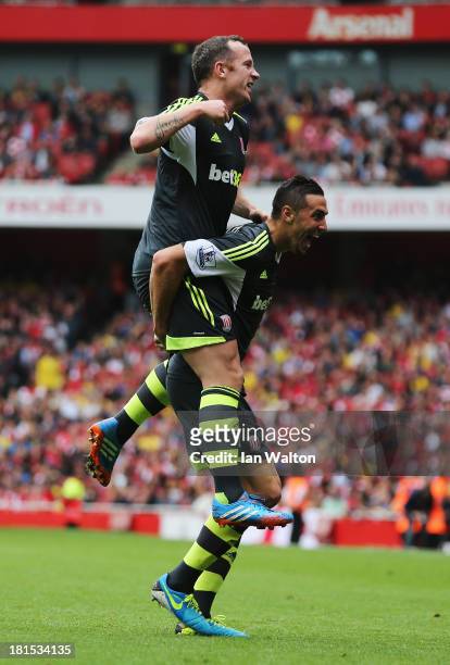 Charlie Adam celebrates on the shoulders of goalscorer Geoff Cameron of Stoke City during the Barclays Premier League match between Arsenal and Stoke...