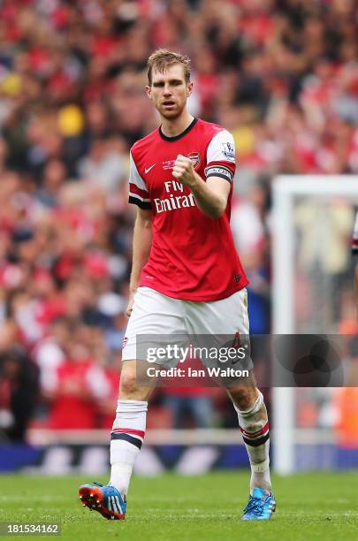 Per Mertesacker of Arsenal celebrates scoring during the Barclays Premier League match between Arsenal and Stoke City at Emirates Stadium on...