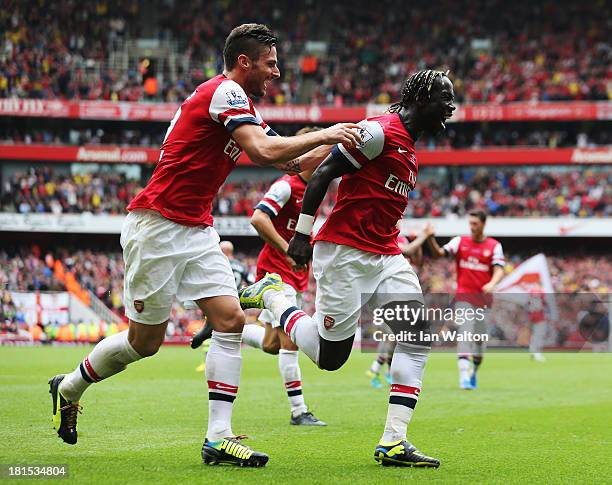 Bacary Sagna of Arsenal celebrates with Olivier Giroud as he scores their third goal during the Barclays Premier League match between Arsenal and...