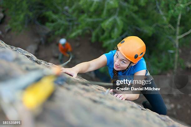 focused young girl rock climbing. - freeclimber stock-fotos und bilder