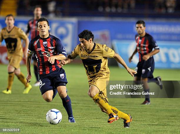 Martin Bravo of Pumas and Jose Guerrero of Atlante fight for the ball during a match between Atlante and Pumas UNAM as part of the Apertura 2013 Liga...