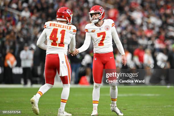 Harrison Butker and James Winchester of the Kansas City Chiefs react during the second quarter of a game against the Las Vegas Raiders at Allegiant...