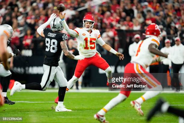 Patrick Mahomes of the Kansas City Chiefs throws a pass over Maxx Crosby of the Las Vegas Raiders during the third quarter at Allegiant Stadium on...