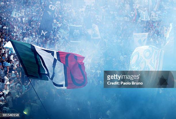 Lazio fans support their team during the Serie A match between AS Roma and SS Lazio at Stadio Olimpico on September 22, 2013 in Rome, Italy.