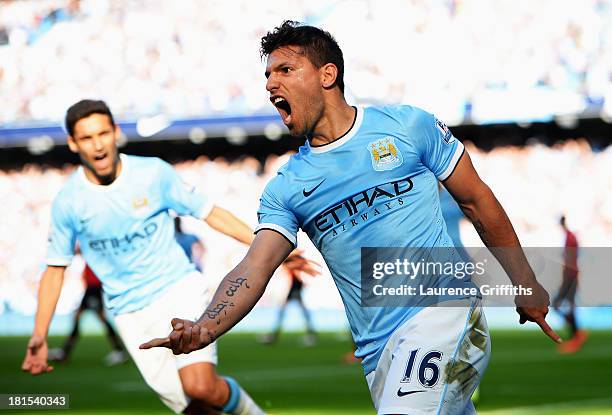 Sergio Aguero of Manchester City celebrates as he scores their first goal during the Barclays Premier League match between Manchester City and...