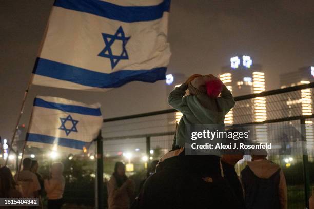 People await the arrival of a helicopter enroute with Israeli hostages released earlier by Hamas arriving at Schneider medical centre on the third...