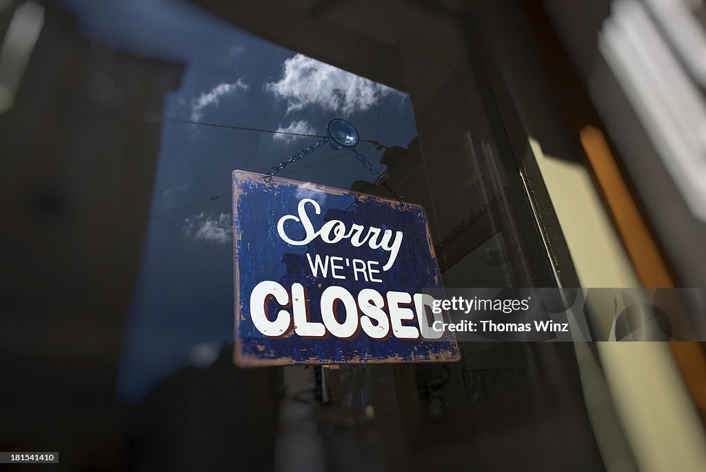 Closed sign on the front door of a shop