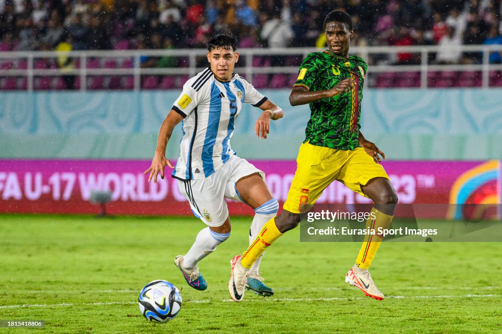 M Ali R Ibrahim Diarra of Mali is chased by Mariano Gerez of Argentina during ...