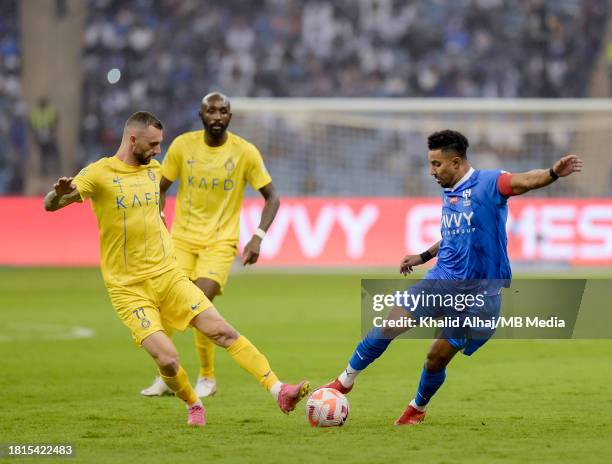 Salem Al-Dawsari of Al-Hilal battles with Marcelo Brozovi of Al-Nassr during the Saudi Pro League match between Al-Hilal and Al-Nassr at King Fahd...