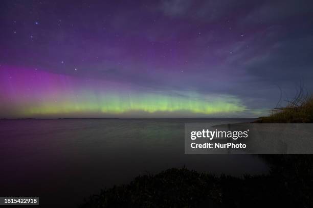 The Aurora Australis is illuminating the night sky above the waters of Lake Ellesmere on the outskirts of Christchurch, New Zealand, on December 1,...