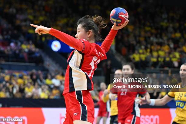 China's wing Yuting Liu shoots during the preliminary round Group A match between Sweden and China of the IHF World Women's Handball Championship in...