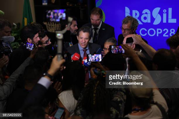 Fernando Haddad, Brazil's finance minister, center, speaks to reporters on day two of the COP28 climate conference at Expo City in Dubai, United Arab...