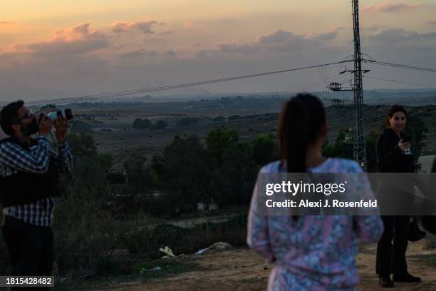 Members of the media and nearby look towards smoke rising from norther gaza on December 1, 2023 as seen from Sderot, Israel. Israel steps up military...