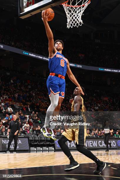 Quentin Grimes of the New York Knicks drives to the basket during the game against the Toronto Raptors on December 1, 2023 at the Scotiabank Arena in...