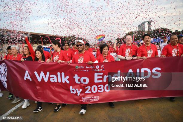 Participants including Philippine health official Enrique Tayag take part in the "walk to end AIDS" event to mark World Aids Day in Manila on...