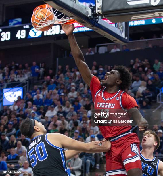 Enoch Boakye of the Fresno State Bulldogs slam dunks the ball over Aly Khalifa of the Brigham Young Cougars during the second half of their game at...