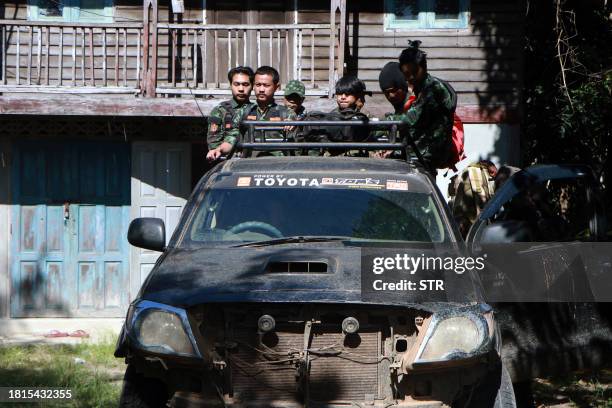 This photo taken on November 28, 2023 shows members of the Loikaw Local People's Defence Force preparing to go to the frontline near Loikaw in...