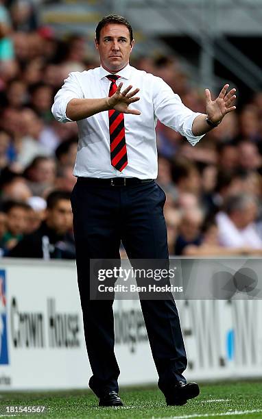 Cardiff manager Malky MacKay gives instructions during the Barclays Premier League match between Cardiff City and Tottenham Hotspur at Cardiff City...