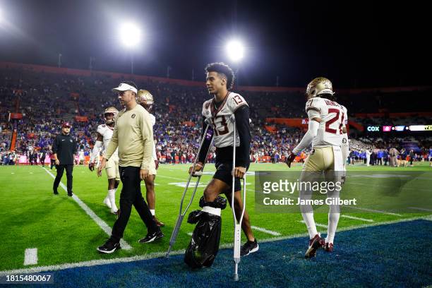Jordan Travis of the Florida State Seminoles walks with crutches before the start of a game against the Florida Gators at Ben Hill Griffin Stadium on...