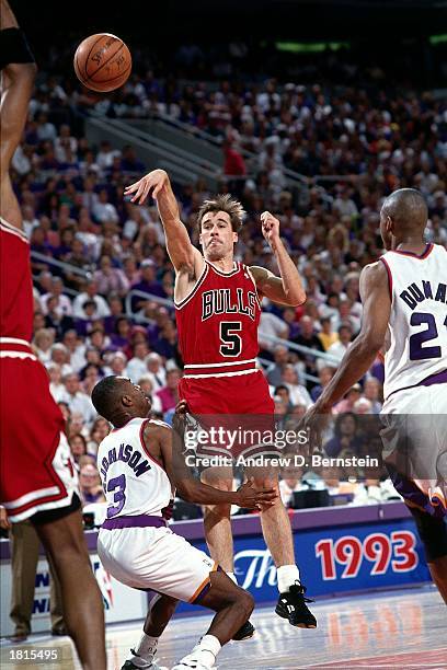 John Paxson of the Chicago Bulls makes a pass against the Phoenix Suns during Game Six of the 1993 NBA Championship Finals at America West Arena on...