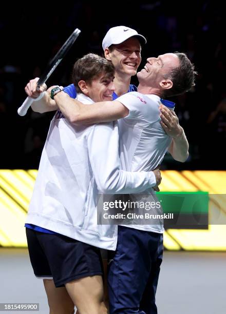 Jannik Sinner of Italy celebrates winning match point with his team captain Filippo Volandri and team mate Matteo Arnaldi during the Davis Cup Final...