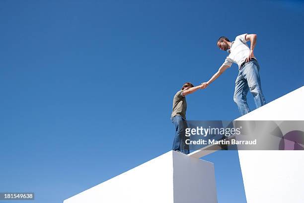 two men walking on board between two walls outdoors - moving toward stock pictures, royalty-free photos & images