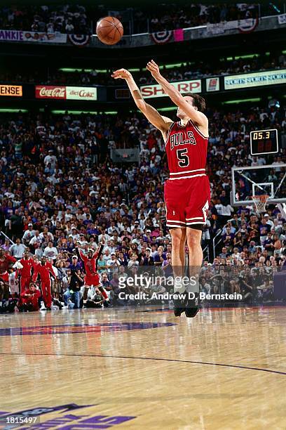 John Paxson of the Chicago Bulls takes a jumper against the Phoenix Suns during Game Six of the 1993 NBA Championship Finals at America West Arena on...