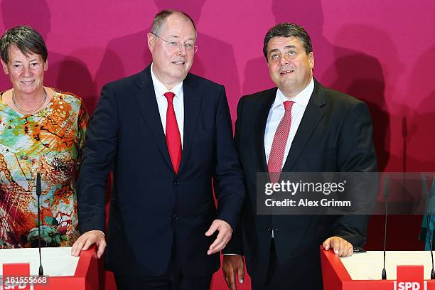 Peer Steinbrueck , chancellor candidate of the German Social Democrats , and chairman Sigmar Gabriel react after initial exit poll results give the...