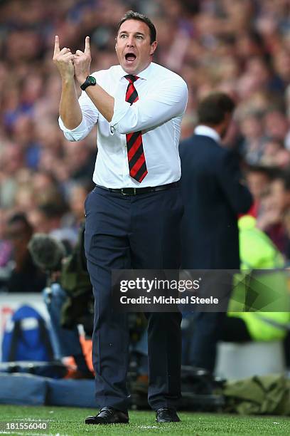 Malkay Mackay the manager of Cardiff City issues instructions during the Barclays Premier League match between Cardiff City and Tottenham Hotspur at...