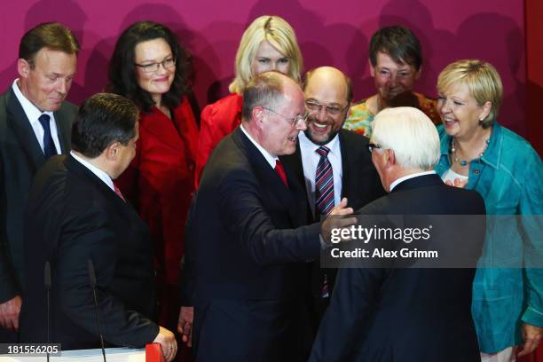 Peer Steinbrueck, chancellor candidate of the German Social Democrats , is surrounded by leading fellow party members after initial exit poll results...