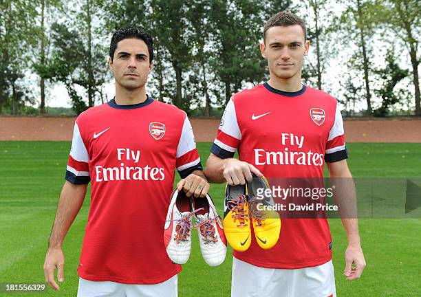 Mikel Arteta and Thomas Vermaelen of Arsenal pose with their rainbow laces during the Arsenal 1st team squad photoshoot at Arsenal Training Ground on...