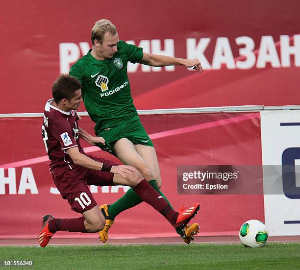 Dmitri Torbinski of FC Rubin Kazan is challenged by Maksim Bardachow of FC Tom Tomsk during the Russian Premier League match between FC Rubin Kazan...