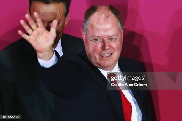 Peer Steinbrueck, chancellor candidate of the German Social Democrats , waves as he leaves the stage after initial exit poll results give the party...