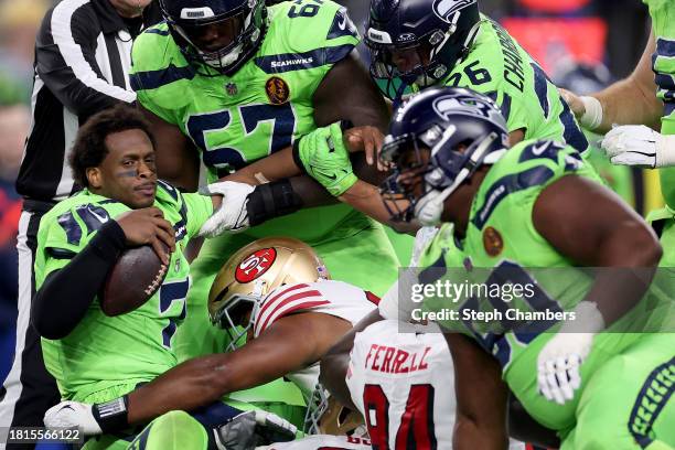 Geno Smith of the Seattle Seahawks looks on after being sacked by the San Francisco 49ers during the fourth quarter at Lumen Field on November 23,...