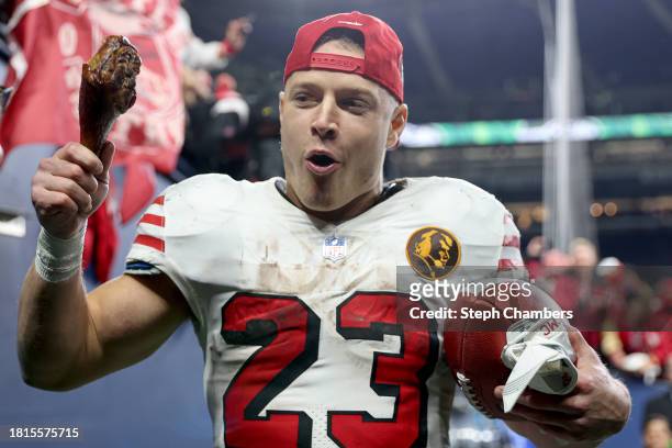Christian McCaffrey of the San Francisco 49ers walks off the field eating a turkey leg after beating the Seattle Seahawks 31-13 at Lumen Field on...