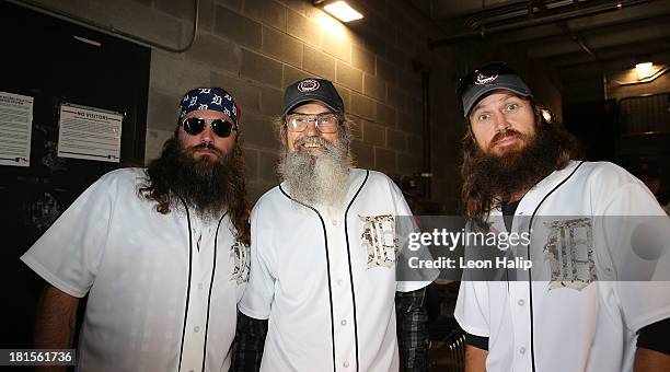 Cast members from Duck Dynasty Willie Robertson, Si Robertson and Phil Robertson get ready to throw out the first pitch prior to the start of the...