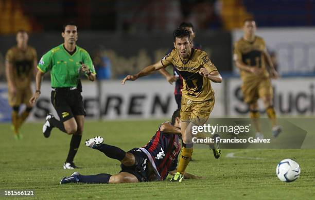 Jose Guerrero of Atlante and Javier Cortez of Pumas fight for the ball during a match between Atlante and Pumas UNAM as part of the Apertura 2013...