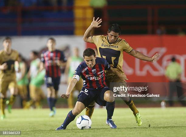 Jose Guerrero of Atlante and Javier Cortez of Pumas fight for the ball during a match between Atlante and Pumas UNAM as part of the Apertura 2013...