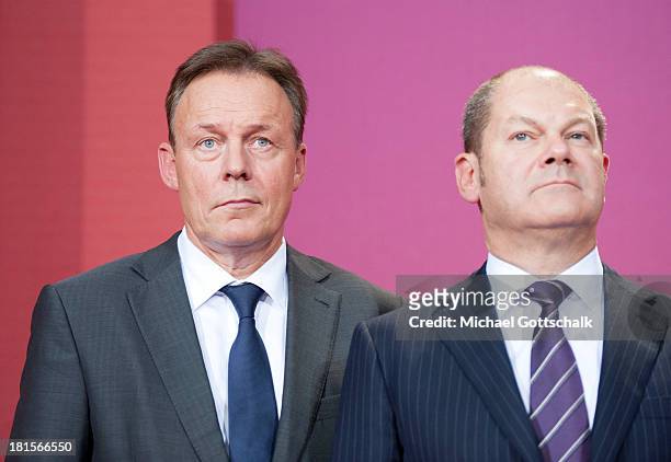 Social Democrats Thomas Oppermann, chairman of the parliamentary control commission of the Bundestag, and Olaf Scholz, Hamburg's First Mayor, look on...