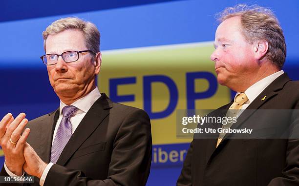 German Foreign Minister Guido Westerwelle and German Development Minister Dirk Niebel react to the announcement of the first projections for the...