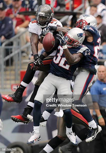 Devin McCourty of the New England Patriots and Aqib Talib of the New England Patriots break up a pass intended for Mike Williams of the Tampa Bay...