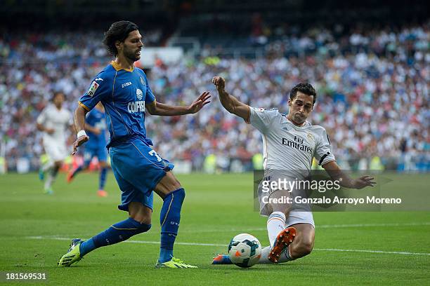 Angel Lafita of Getafe CF competes for the ball with Alvaro Arbeloa of Real Madrid CF during the La Liga match between Real Madrid CF and Getafe CF...