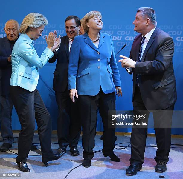 Angela Merkel , German Chancellor and Chairwoman of the German Christian Democrats , celebrates with leading members of her party, including Minister...