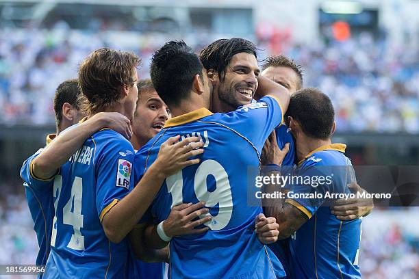 Angel Lafita of Getafe CF celebrates scoring their opening goal with teammates during the La Liga match between Real Madrid CF and Getafe CF at...