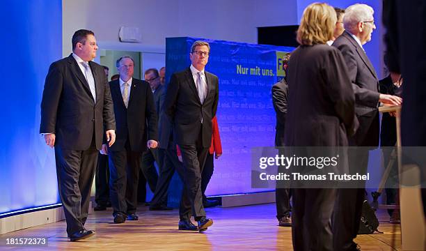 Patrick Doering, German Development Minister Dirk Niebel, German Foreign Minister Guido Westerwelle enter the stage after the announcement of the...