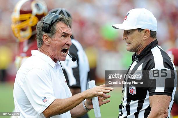 Head coach Mike Shanahan of the Washington Redskins argues a call with referee Ed Hochuli in the fourth quarter against the Detroit Lions at...