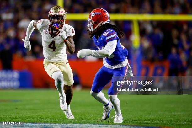 Keon Coleman of the Florida State Seminoles runs a route against Jaydon Hill of the Florida Gators during the second half of a game at Ben Hill...